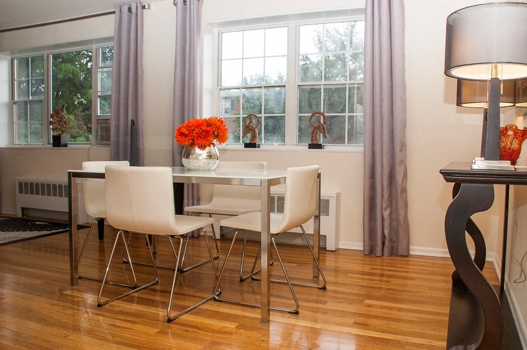 dining area with table, chairs, large windows and hardwood floors at ridgecrest village in washington dc