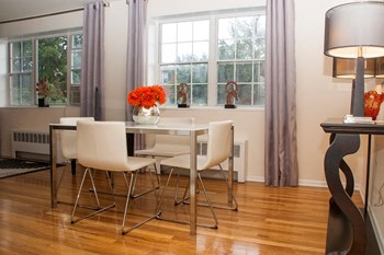 dining area with table, chairs, large windows and hardwood floors at ridgecrest village in washington dc - Photo Gallery 5