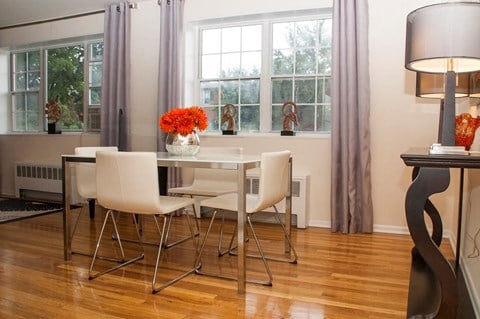 dining area with table, chairs, large windows and hardwood floors at ridgecrest village in washington dc