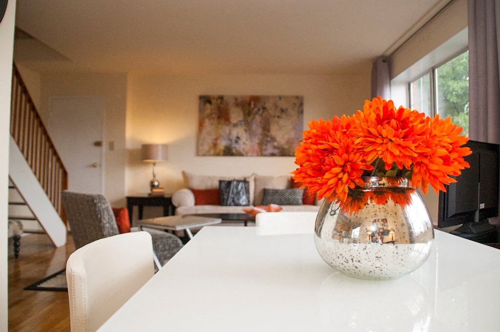 Dining area with view of living area with window and staircase at ridgecrest village in washington dc