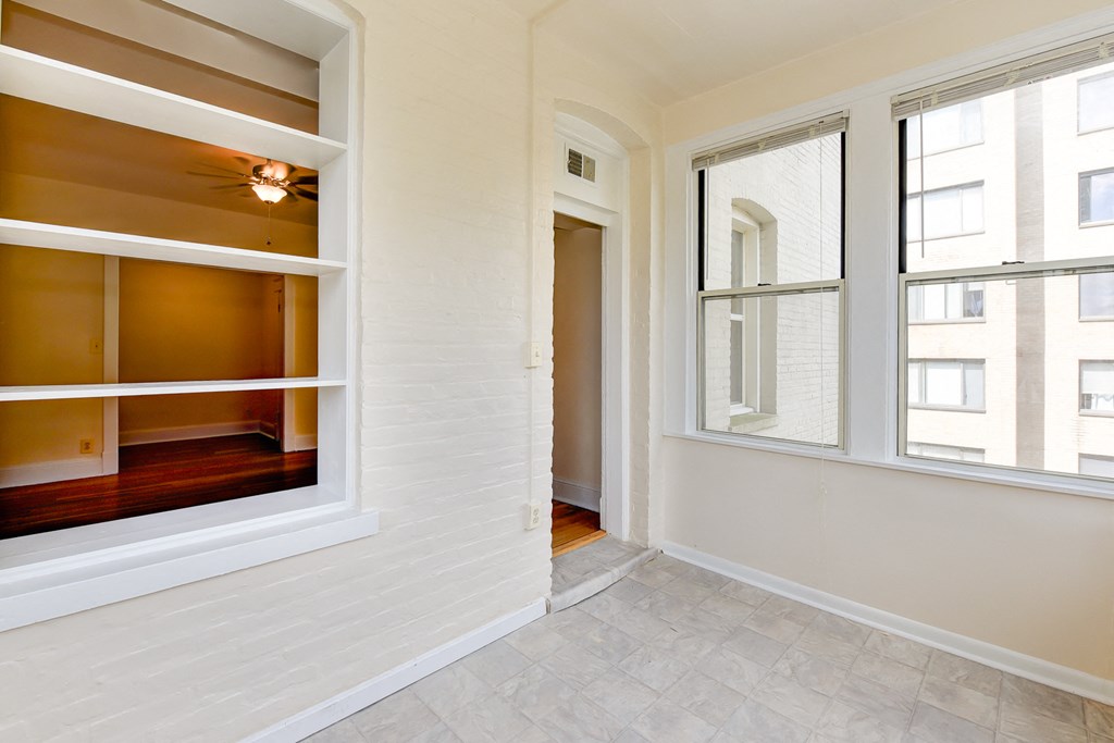 vacant sunroom with hardwood floors and large windows at twin oaks apartments columbia heights washington dc