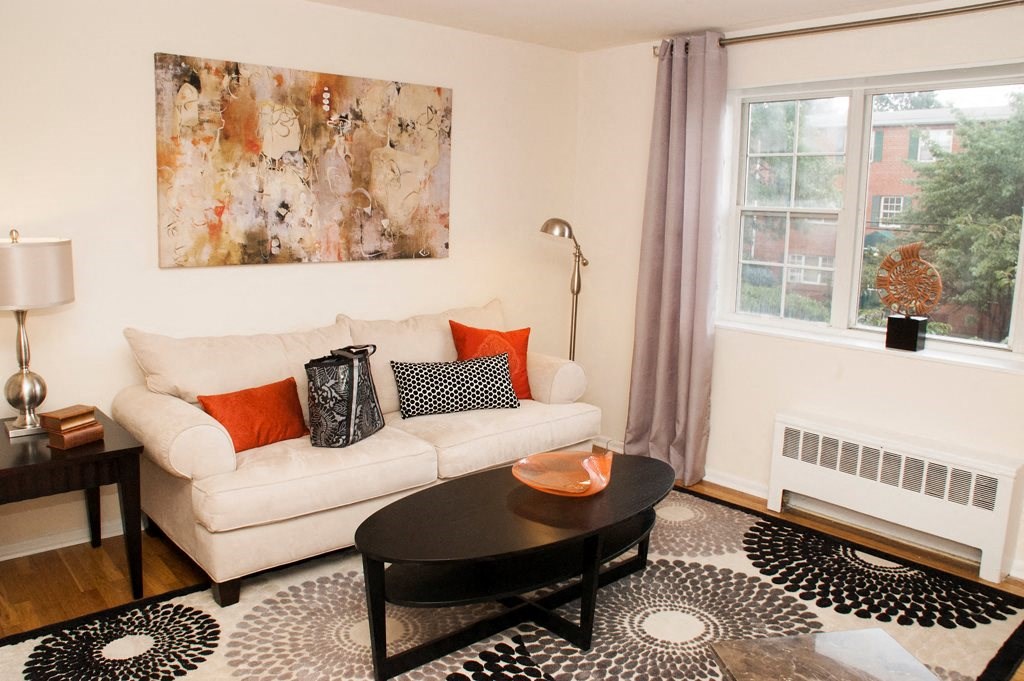 living area with sofa, coffee table and large windows at ridgecrest village in washington dc