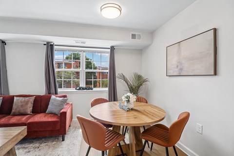 A dining room with a round table and chairs.