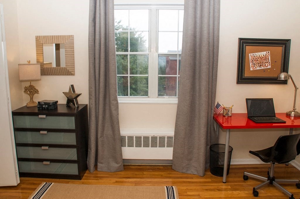 home office area with desk, storage cabinet, large windows and hardwood flooring at ridgecrest village in washington dc
