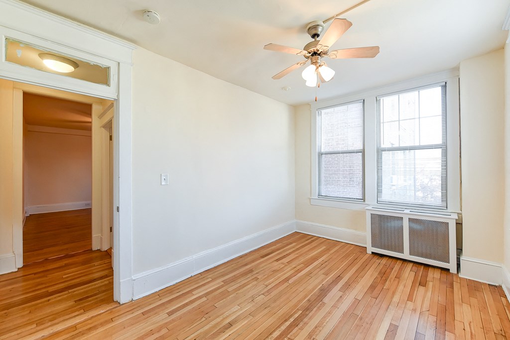 vacant bedroom with hardwood flooring and ceiling fan at the cortland apartments in washington dc