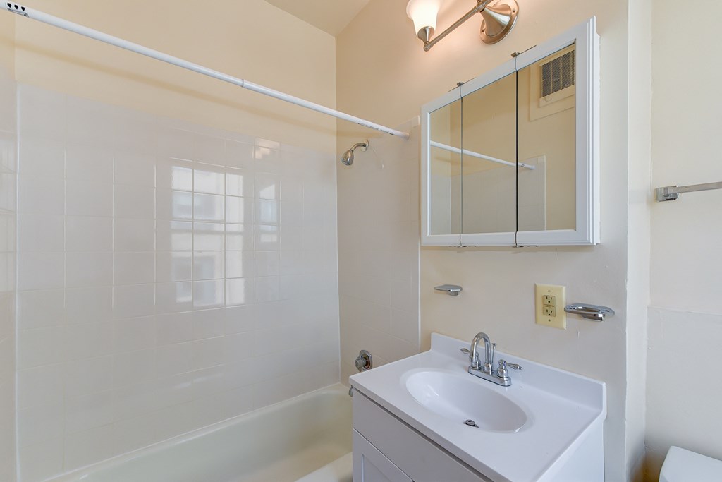 bathroom with toilet, vanity, tub, and medicine cabinet at twin oaks apartments columbia heights washington dc