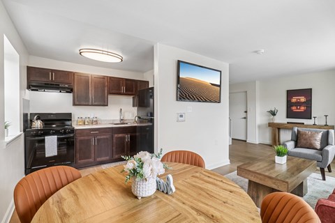 A modern kitchen with a wooden table set for a meal.