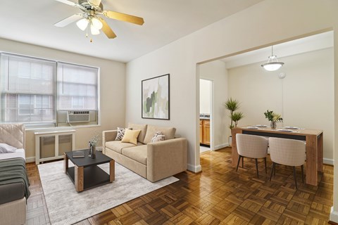 A living room with a brown coffee table and a beige couch.
