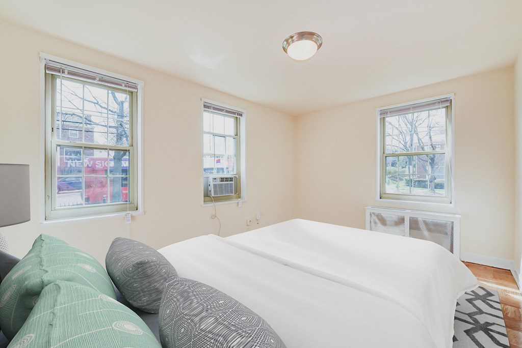 bedroom with bed, windows and hardwood floors 1401 sheridan apartments in washington dc