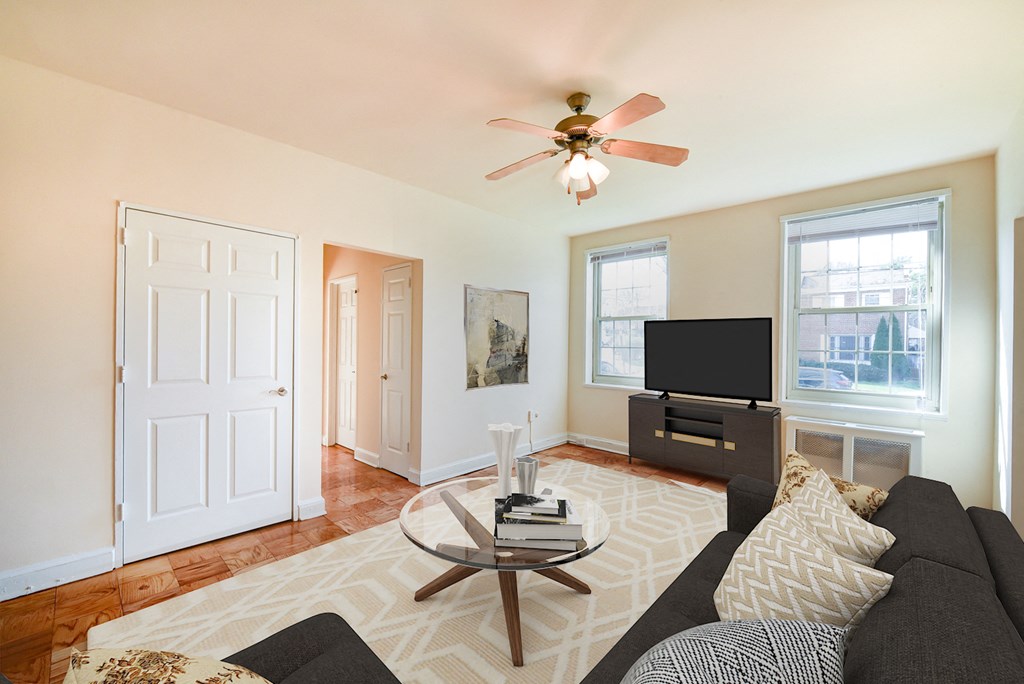 living area with sofa, large windows, tv, and hardwood flooring 1401 sheridan apartments in washington dc