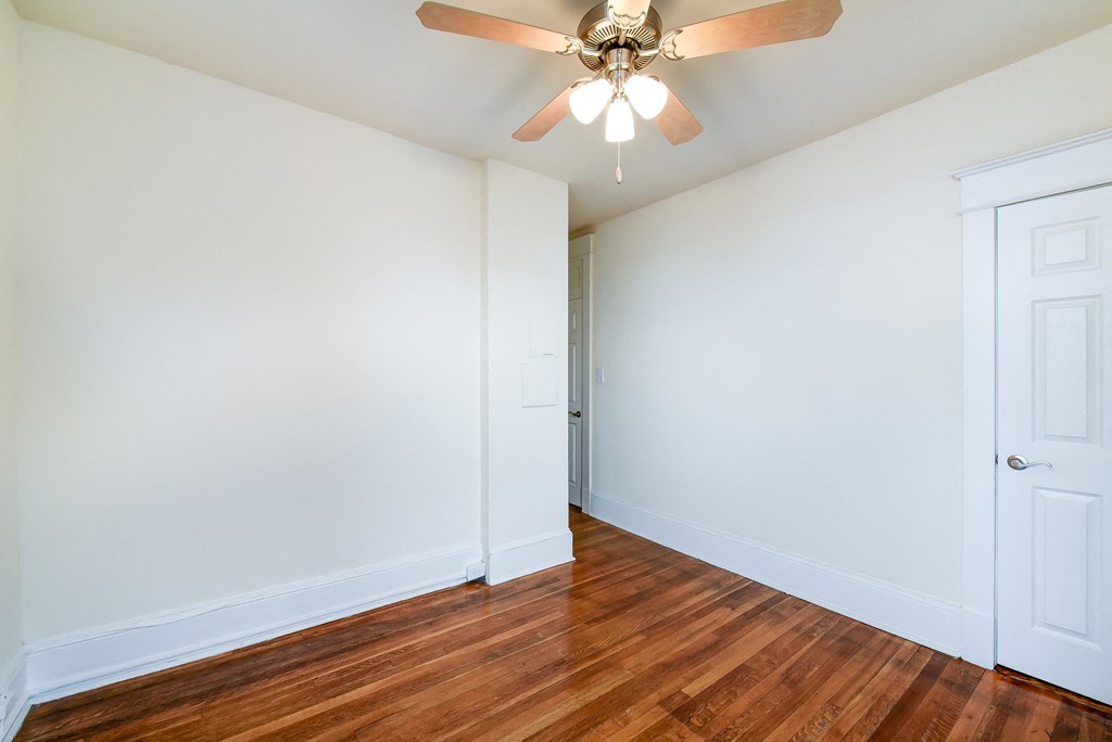 vacant bedroom with hardwood flooring and ceiling fan at the cortland apartments in washington dc