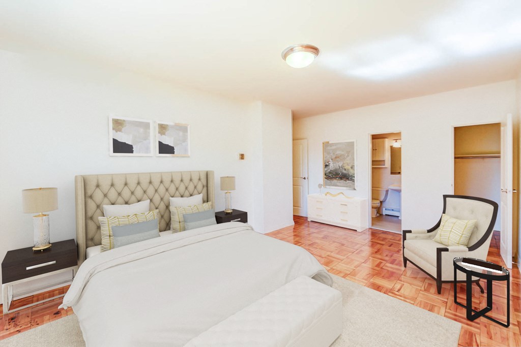 bedroom with bed, night stands, sitting area and view of closet and bathroom at clarence house apartments in washington dc