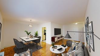 living area with sofa, coffee table, credenza, tv, hardwood floors and view of dining area at clarence house apartments in washington dc