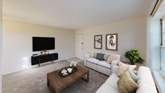 living area with sofa, coffee table, credenza, tv and view of front entrance at manor village apartments in washington dc