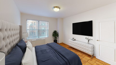 bedroom with bed, night stands, dresser, tv and large window at clarence house apartments in washington dc