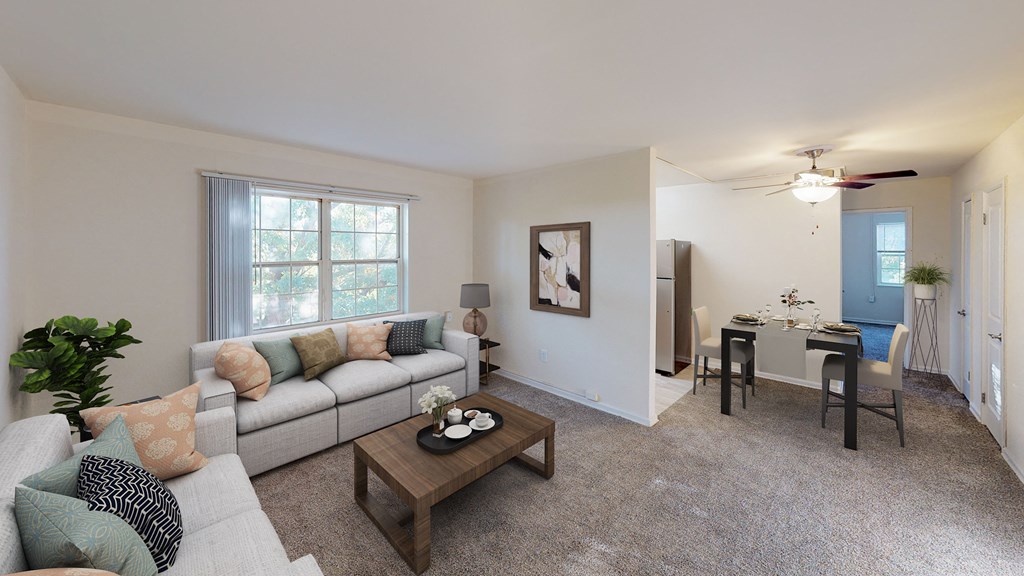 living area with sofa, coffee table, windows and view of dining area at manor village  tax credit apartments in washington dc