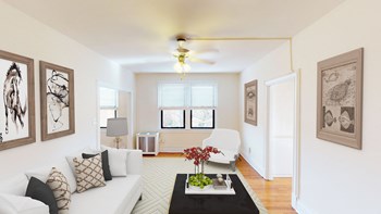 living area with sofa, seating area, coffee table, modern artwork and ceiling fan at the klingle apartments in washignton dc - Photo Gallery 4