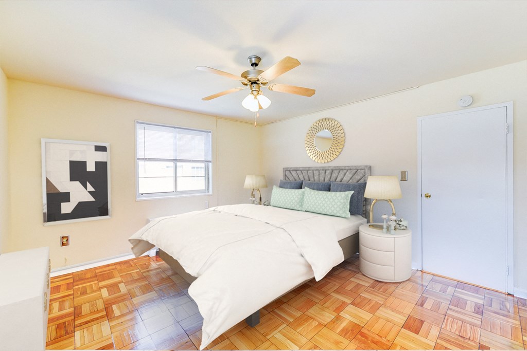 bedroom with bed, nightstands, hardwood flooring and ceiling fan at new horizon apartments in washington dc