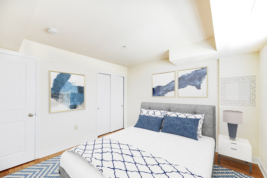 bedroom with bed, nightstand, and closet at jasper place apartments in washington dc