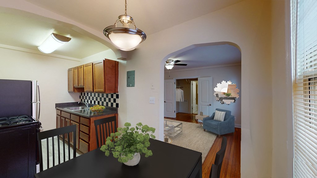 dining area with table, chairs, view of kitchen and living area at 2801 pennsylvania apartments in washington dc