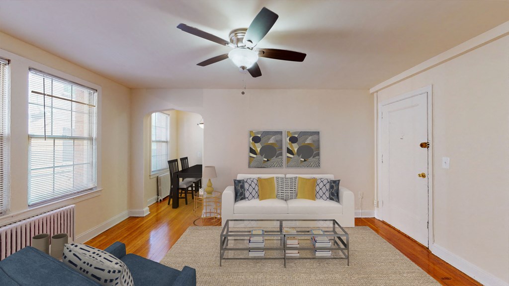living area with sofa, coffee table, large window, ceiling fan and hardwood floors at 2801 pennsylvania apartments in washington dc