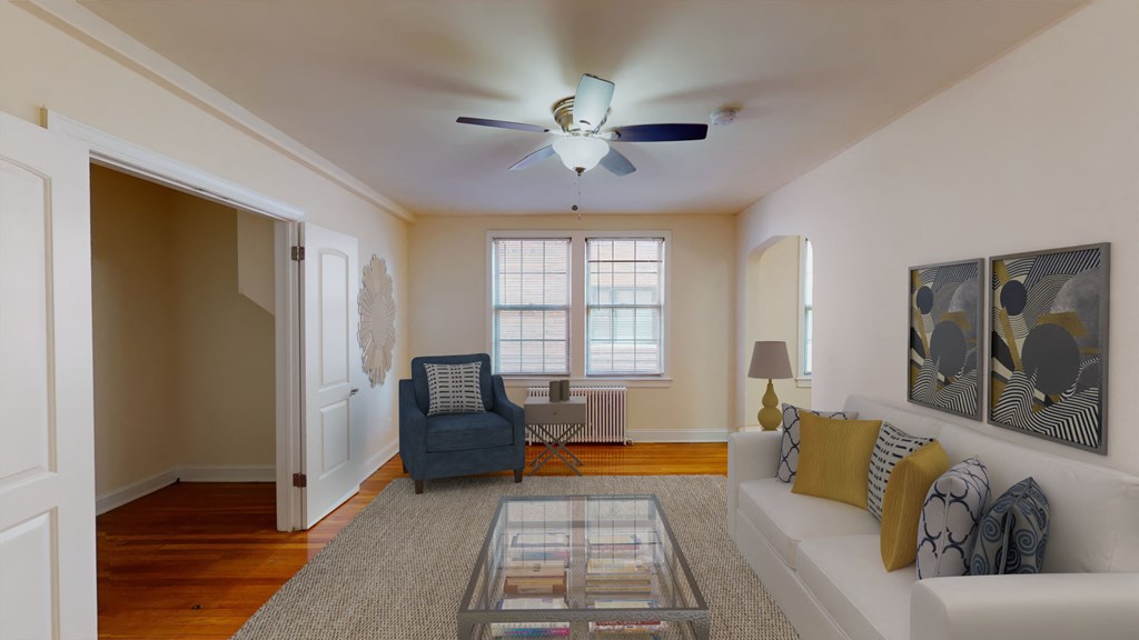 living area with sofa, coffee table, large window, ceiling fan and hardwood floors at 2801 pennsylvania apartments in washington dc