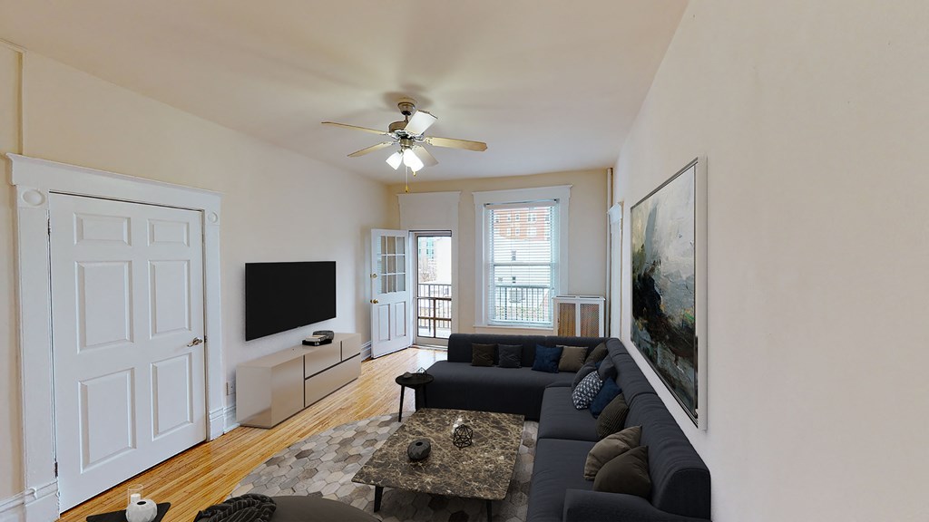 living area with sofa, coffee table, credenza, tv, ceiling fan and view of balcony at dupont apartments in washington dc