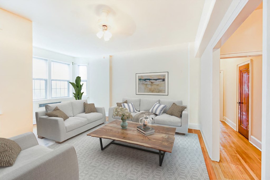 living area with sofa, coffee table, hardwood floors, large windows and ceiling fan  at 2800 ontario road apartments in washington dc
