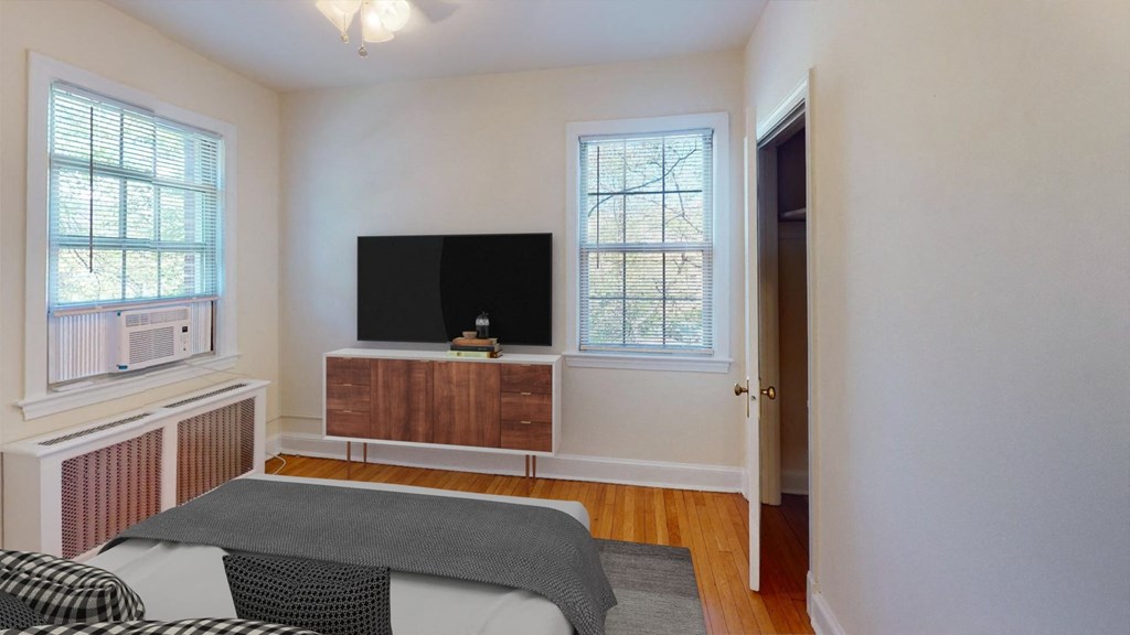 a bedroom with a bed and a television