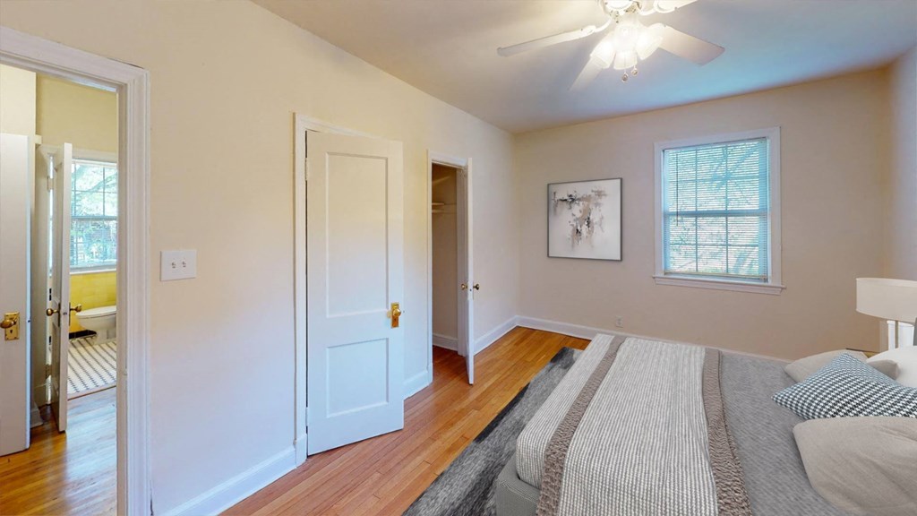 a bedroom with a large bed and a ceiling fan