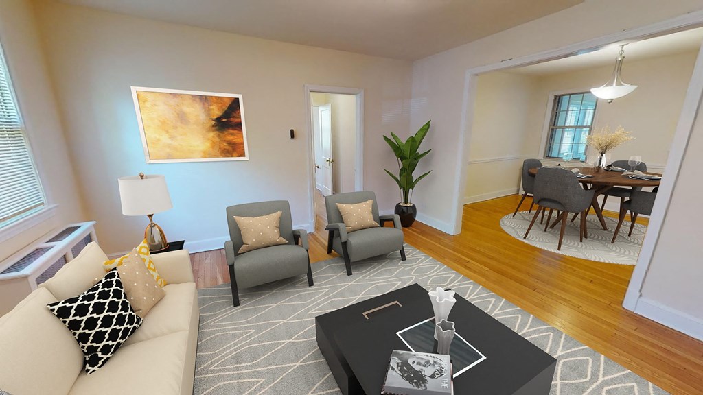 a living room with a couch chairs and a coffee table