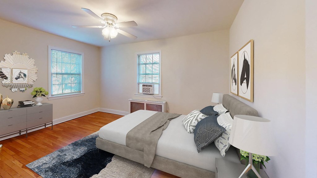 a bedroom with a bed and two windows