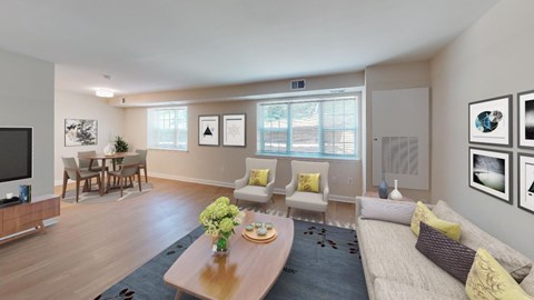 A living room with a couch, chairs, and a coffee table.