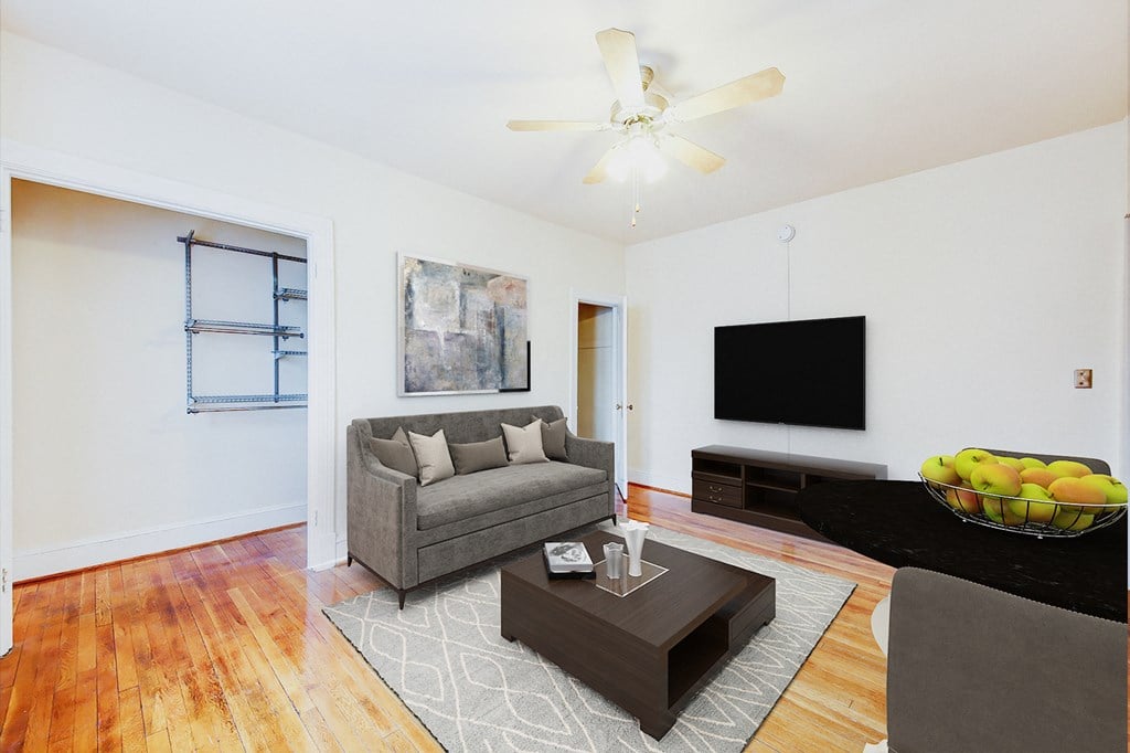 living area with sofa, coffee table, hardwood floors and ceiling fan at 1818 riggs apartments in washington dc