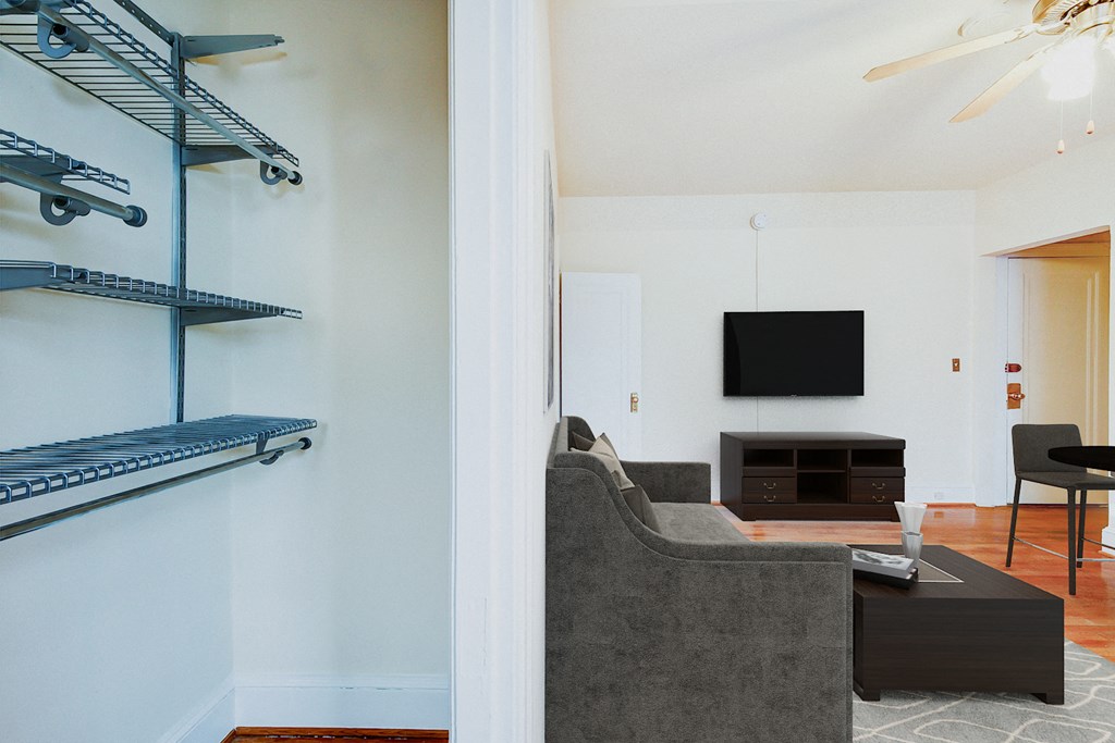 living area with sofa, coffee table, hardwood floors and large closet at 1818 riggs apartments in washington dc