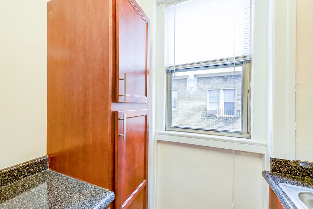 kitchen with modern cabinetry and window at chatham courts apartments in washington dc