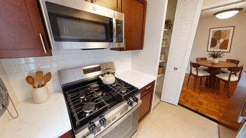 A kitchen with a stove top oven and a microwave above it.