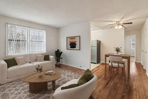 A living room with a white couch, a wooden coffee table, and a painting on the wall.