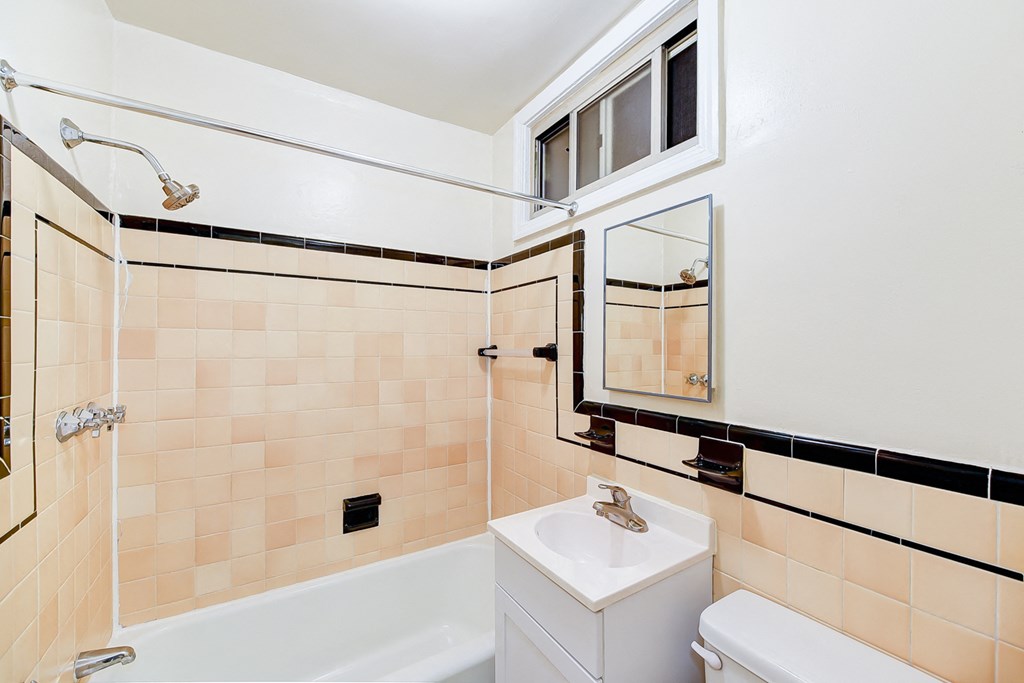 bathroom with tub, vanity, toilet and tile details at  2629 39th Street apartments in washington dc
