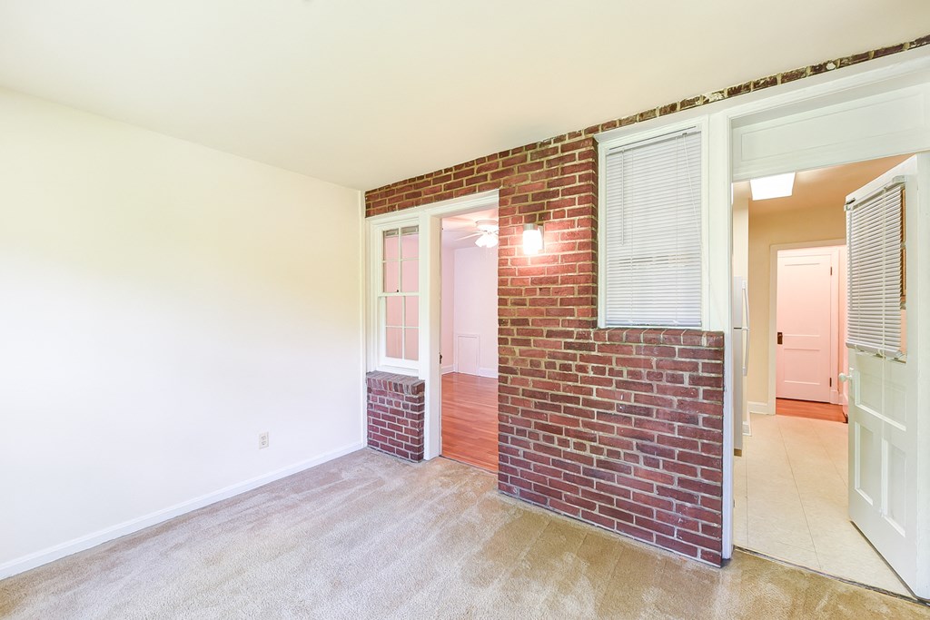 vacant sunroom with exposed brick  at  2629 39th Street apartments in washington dc