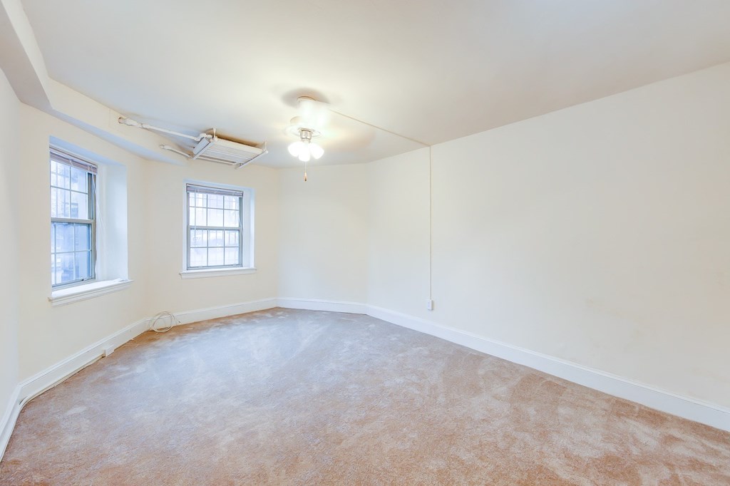 vacant bedroom with plush carpeting, windows and ceiling fan at 2800 ontario apartments in washington dc