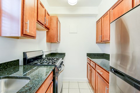 a kitchen with granite counter tops and stainless steel appliances