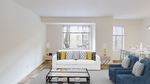 a living room with a couch and a coffee table and a window