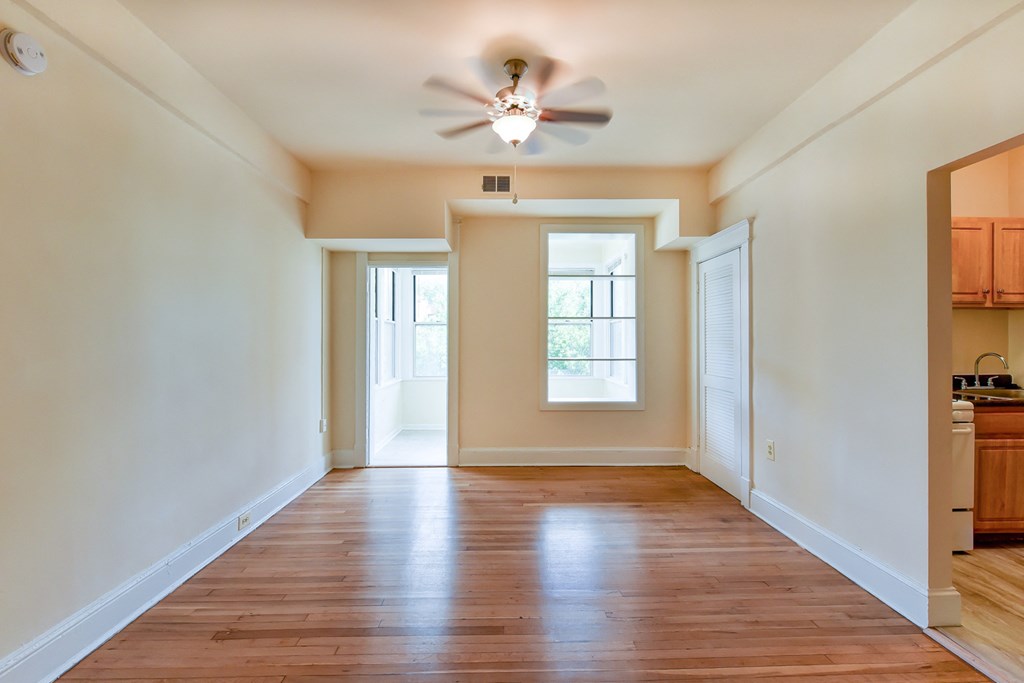 vacant living area with large windows, hard wood flooring and ceiling fan  at twin oaks apartments columbia heights washington dc