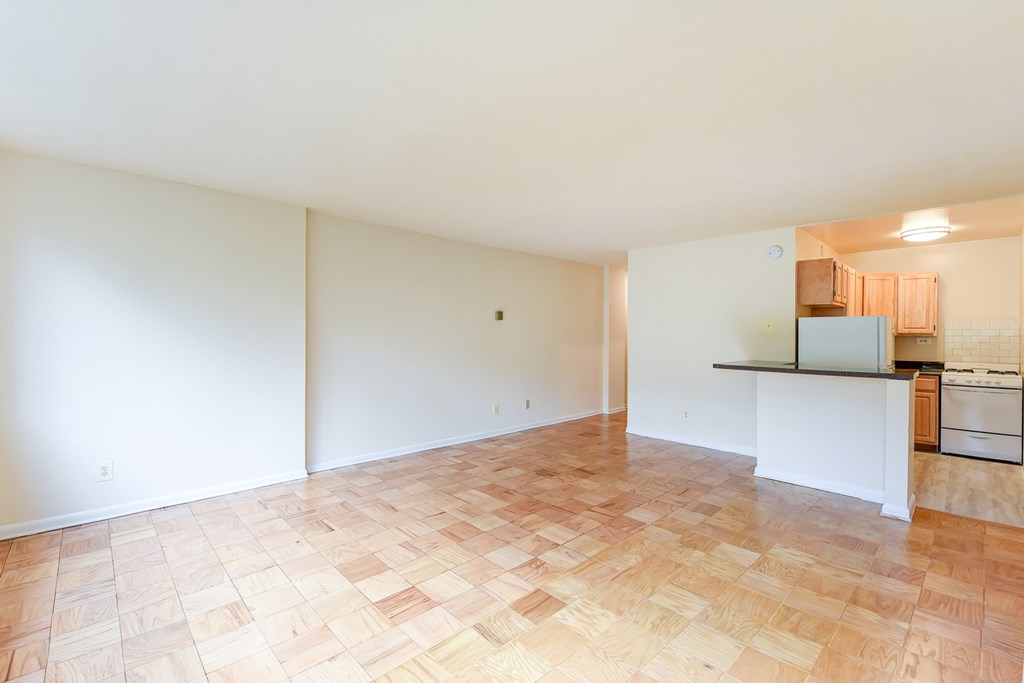 vacant living area with hard wood flooring and view of kitchen  at twin oaks apartments columbia heights washington dc