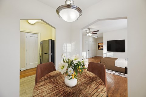A dining room with a wooden table and chairs.