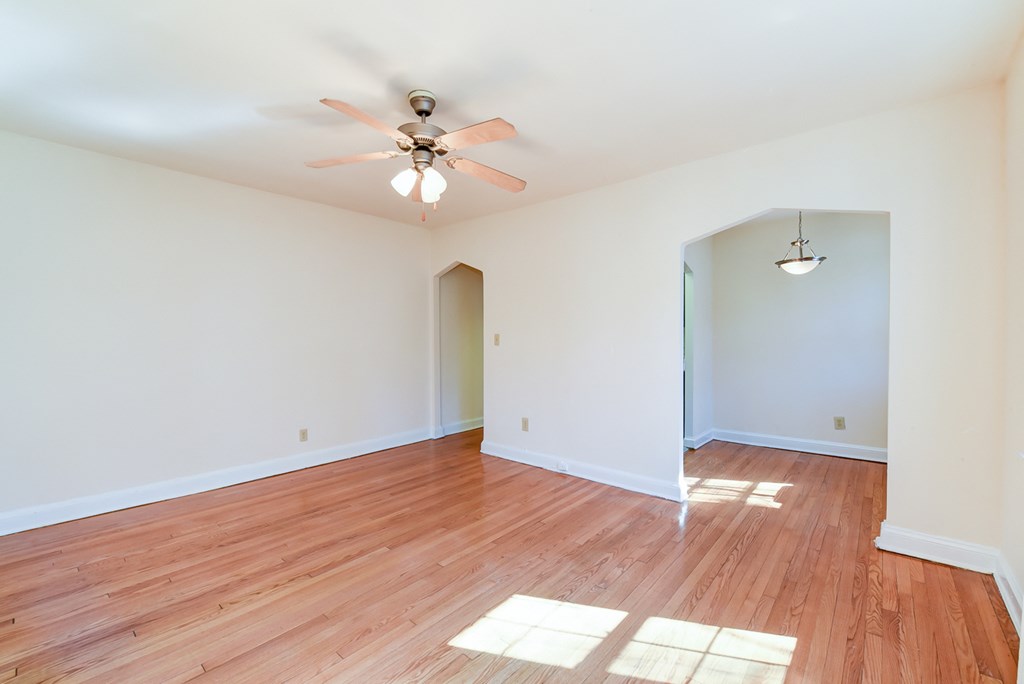 vacant living area with hardwood flooring and ceiling fan at 3101 Pennsylvania apartments in washington dc