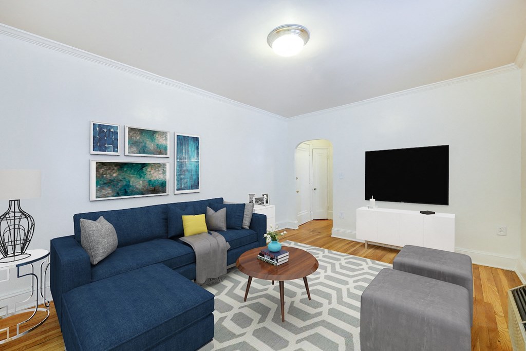 living area with sofa, coffee table, credenza, tv, hardwood flooring and modern artwork at 3213 wisconsin apartments in washington dc