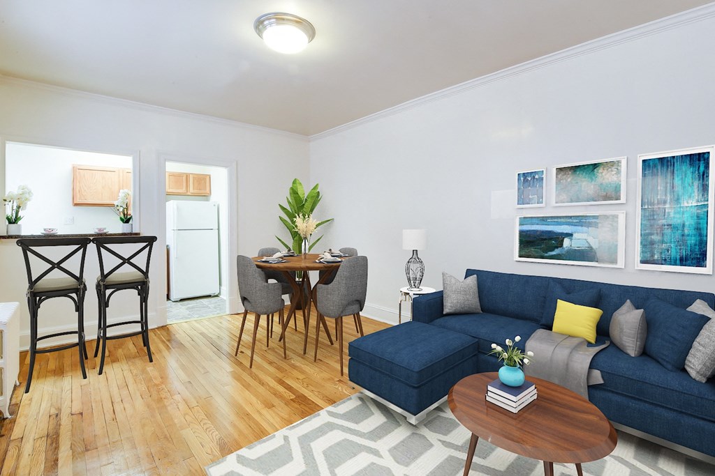 living area with sofa, coffee table, and views of kitchen and dining areas at 3213 wisconsin apartments in washington dc