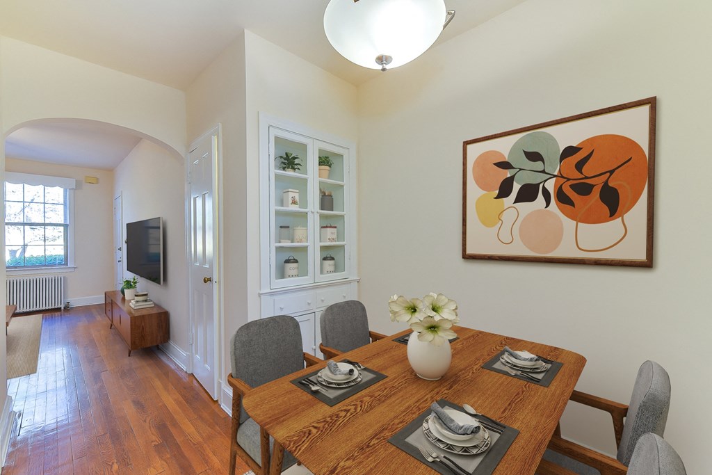 a dining room with a wooden table and chairs